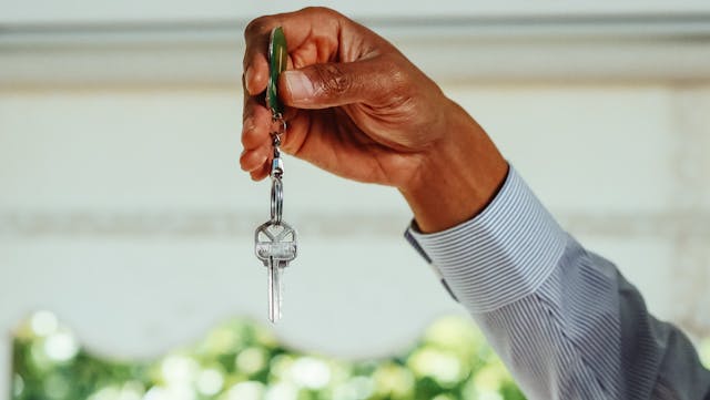 someone holding up a house key